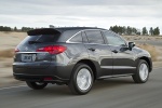 Picture of a driving 2015 Acura RDX in Graphite Luster Metallic from a rear three-quarter perspective