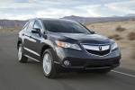 Picture of a driving 2015 Acura RDX in Graphite Luster Metallic from a front right perspective