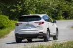 Picture of a driving 2019 Acura RDX SH-AWD in White Diamond Pearl from a rear right perspective