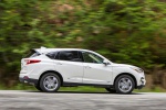 Picture of a driving 2019 Acura RDX SH-AWD in White Diamond Pearl from a right side perspective