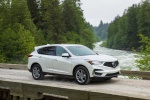 Picture of a driving 2019 Acura RDX SH-AWD in White Diamond Pearl from a front right three-quarter perspective