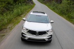 Picture of a driving 2019 Acura RDX SH-AWD in White Diamond Pearl from a frontal perspective