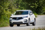 Picture of a driving 2019 Acura RDX SH-AWD in White Diamond Pearl from a front left perspective