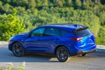 Picture of a driving 2019 Acura RDX A-Spec Package SH-AWD in Apex Blue Pearl from a rear left three-quarter perspective