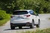 Picture of a driving 2020 Acura RDX SH-AWD in Platinum White Pearl from a rear right perspective