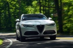 Picture of a driving 2018 Alfa Romeo Stelvio Ti Lusso AWD in Trofeo White Tri-Coat from a front right perspective