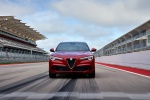 Picture of a driving 2020 Alfa Romeo Stelvio Quadrifoglio AWD in Rosso Competizione Tri-Coat from a frontal perspective