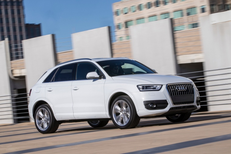 Picture of a driving 2015 Audi Q3 2.0T in Cortina White from a front right three-quarter perspective