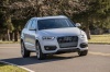 Picture of a driving 2015 Audi Q3 2.0T in Cortina White from a front right perspective