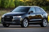 Picture of a driving 2016 Audi Q3 2.0T quattro in Brilliant Black from a front left three-quarter perspective