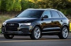 Picture of a driving 2017 Audi Q3 2.0T quattro in Brilliant Black from a front left three-quarter perspective