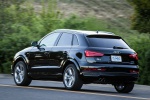 Picture of a driving 2017 Audi Q3 2.0T quattro in Brilliant Black from a rear left three-quarter perspective