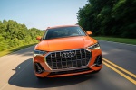 Picture of a driving 2019 Audi Q3 45 quattro in Pulse Orange from a frontal perspective
