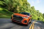 Picture of a driving 2019 Audi Q3 45 quattro in Pulse Orange from a front left perspective