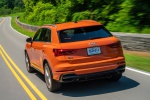 Picture of a driving 2019 Audi Q3 45 quattro in Pulse Orange from a rear left perspective