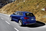 Picture of a driving 2015 Audi SQ5 Quattro in Scuba Blue Metallic from a rear left three-quarter perspective