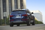 Picture of a driving 2015 Audi SQ5 Quattro in Scuba Blue Metallic from a rear right perspective