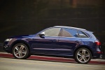 Picture of a driving 2015 Audi SQ5 Quattro in Scuba Blue Metallic from a side perspective