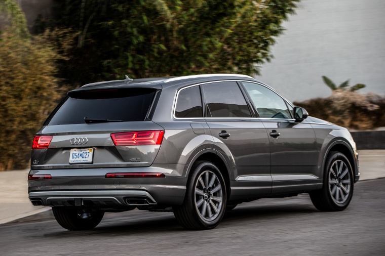 Picture of a driving 2017 Audi Q7 3.0T quattro in Graphite Gray Metallic from a rear right three-quarter perspective