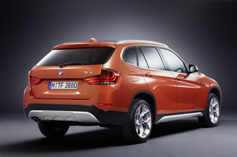 Picture of a 2014 BMW X1 in Valencia Orange Metallic from a rear right three-quarter perspective