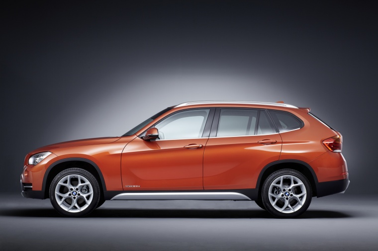 Picture of a 2014 BMW X1 in Valencia Orange Metallic from a left side perspective