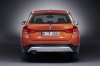 Picture of a 2014 BMW X1 in Valencia Orange Metallic from a rear perspective