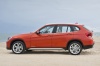 Picture of a 2014 BMW X1 in Valencia Orange Metallic from a left side perspective
