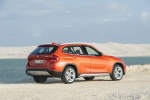 Picture of a 2014 BMW X1 in Valencia Orange Metallic from a rear right three-quarter perspective