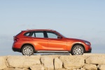 Picture of a 2014 BMW X1 in Valencia Orange Metallic from a right side perspective