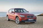 Picture of a 2014 BMW X1 in Valencia Orange Metallic from a front right perspective