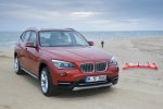 Picture of a 2014 BMW X1 in Valencia Orange Metallic from a front right perspective