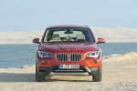 Picture of a 2014 BMW X1 in Valencia Orange Metallic from a frontal perspective