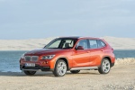 Picture of a 2014 BMW X1 in Valencia Orange Metallic from a front left three-quarter perspective