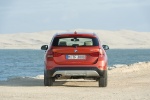 Picture of a 2014 BMW X1 in Valencia Orange Metallic from a rear perspective