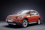 Picture of a 2014 BMW X1 in Valencia Orange Metallic from a front left three-quarter perspective