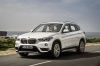 Picture of a driving 2016 BMW X1 xDrive28i in Alpine White from a front left three-quarter perspective