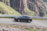 Picture of a driving 2016 BMW X1 xDrive28i in Jet Black from a side perspective