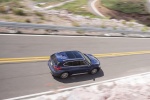 Picture of a driving 2016 BMW X1 xDrive28i in Mediterranean Blue from a rear right three-quarter perspective