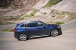 Picture of a driving 2016 BMW X1 xDrive28i in Mediterranean Blue from a side perspective