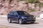 Picture of a driving 2016 BMW X1 xDrive28i in Mediterranean Blue from a front right three-quarter perspective