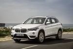 Picture of a driving 2017 BMW X1 xDrive28i in Alpine White from a front left three-quarter perspective