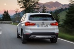 Picture of a driving 2017 BMW X1 xDrive28i in Alpine White from a rear perspective