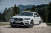 Picture of a driving 2018 BMW X1 xDrive28i in Alpine White from a front left three-quarter perspective