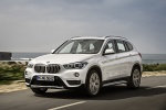 Picture of a driving 2019 BMW X1 xDrive28i in Alpine White from a front left three-quarter perspective