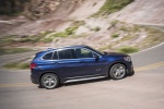Picture of a driving 2019 BMW X1 xDrive28i in Mediterranean Blue from a side perspective