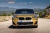 Picture of a driving 2018 BMW X2 in Galvanic Gold Metallic from a frontal perspective