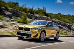 Picture of a driving 2018 BMW X2 in Galvanic Gold Metallic from a front left three-quarter perspective