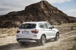 Picture of a driving 2015 BMW X3 in Mineral White Metallic from a rear right three-quarter perspective