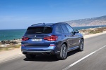 Picture of a driving 2018 BMW X3 M40i in Phytonic Blue Metallic from a rear right perspective