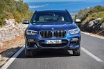 Picture of a driving 2018 BMW X3 M40i in Phytonic Blue Metallic from a frontal perspective